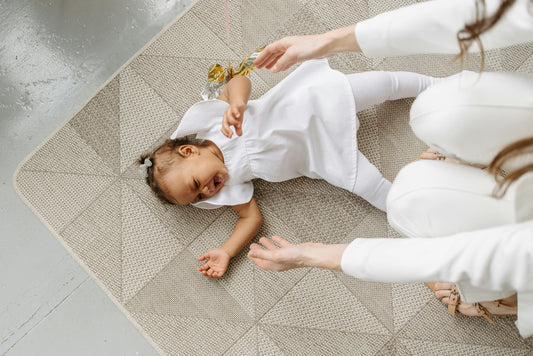 A photo of a baby lying on a baby play cushion, locally made in South Africa